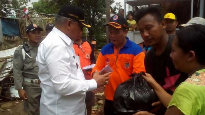 Bupati Malang, Rendra Kresna, ditemani Kepala BPBD, Kalaksa Iriantoro saat menyerahkan bantuan ke masyarakat.