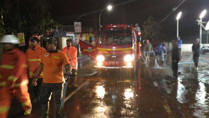Personel gabungan dibantu warga melakukan pembersihan material lumpur pasca banjir, Selasa (21/11). (Pusdalops BPBD Kota Batu)