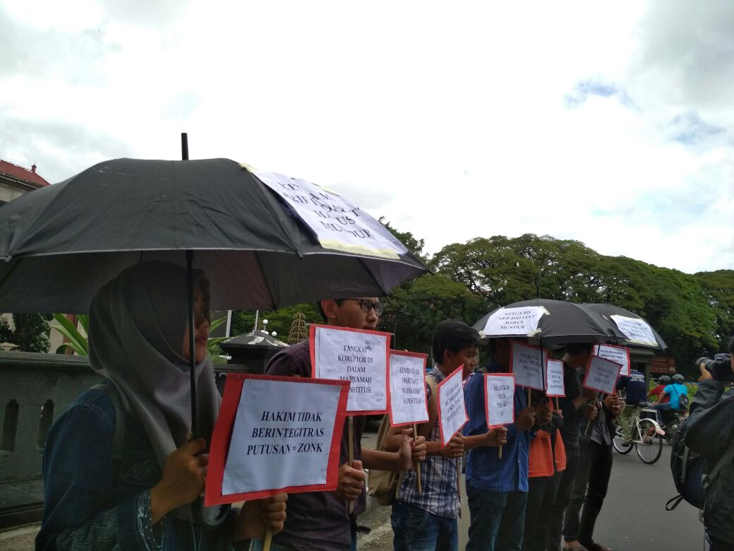 MCW bersama Koalisi Masyarakat Peduli MK menggelar aksi di depan Balai Kota Malang. (Muhammad Choirul)