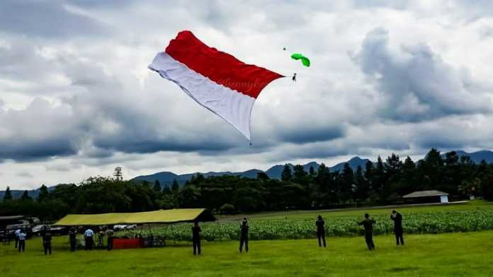 Detik- detik pengibaran bendera merah putih raksasa dengan terjun payung oleh prajurit Den Matra 2 Paskhas Serka Sriyanto, Rabu (28/3). (istimewa)